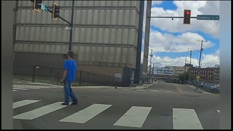 Catatonic homeless man frozen motionless in middle of busy intersection