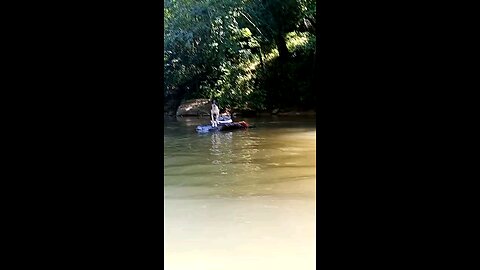 Man teaches dog how to swim