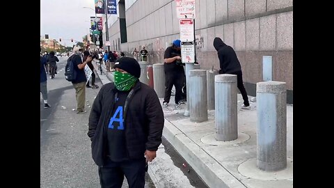Masked insurrectionist in LA making cement rocks to throw at ICE officers. Rioters using violence