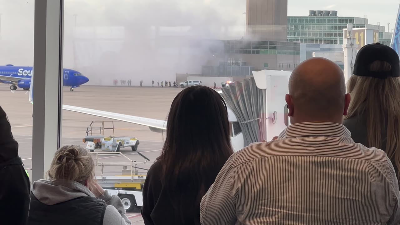 Smoke Billows From Grounded Airplane