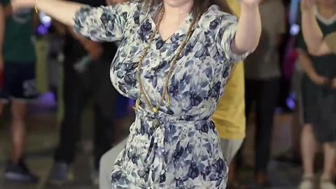 This young busty beautiful Chinese girl dances with pensioners on the street every day