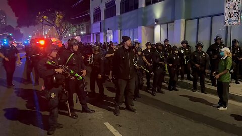 Rioters are being arrested and taken in to a LAPD shuttle bus.