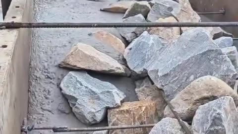 Pouring Concrete Between Rocks