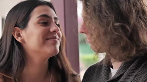 Girl surprises her boyfriend with a kiss