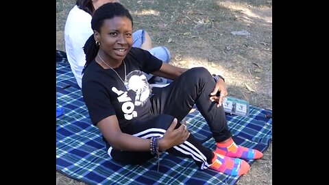 Luodong Very Briefly Treats Black Woman's Foot On The Picnic Blanket