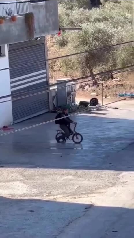 An Israeli female soldier was seen riding a Palestinian child’s bicycle after seizing it from the street during an Israeli army raid in the town of Kafr Qaddum, east of Qalqilya, today