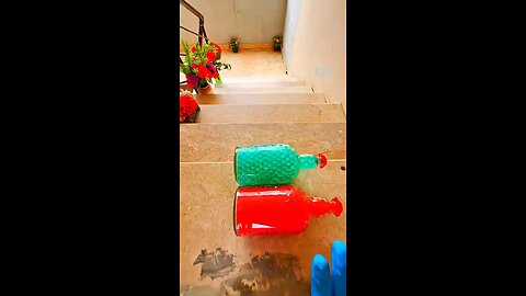 Incredible different colours of bottles falling from stairs to check hardness