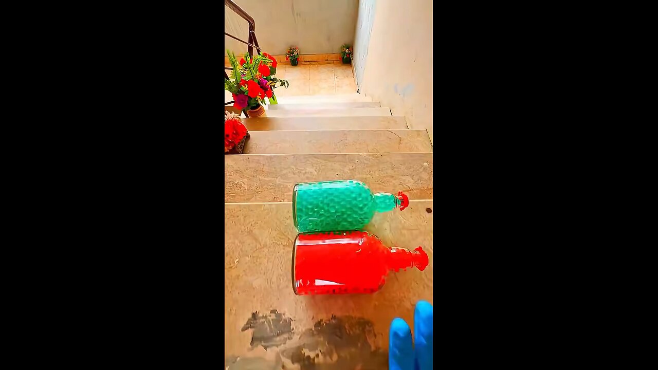 Incredible different colours of bottles falling from stairs to check hardness