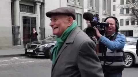 87-year-old Holocaust survivor, Stephen Kapos, walks to the police station
