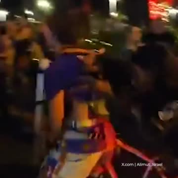 Israeli protesters holding pictures of starving Palestinian children