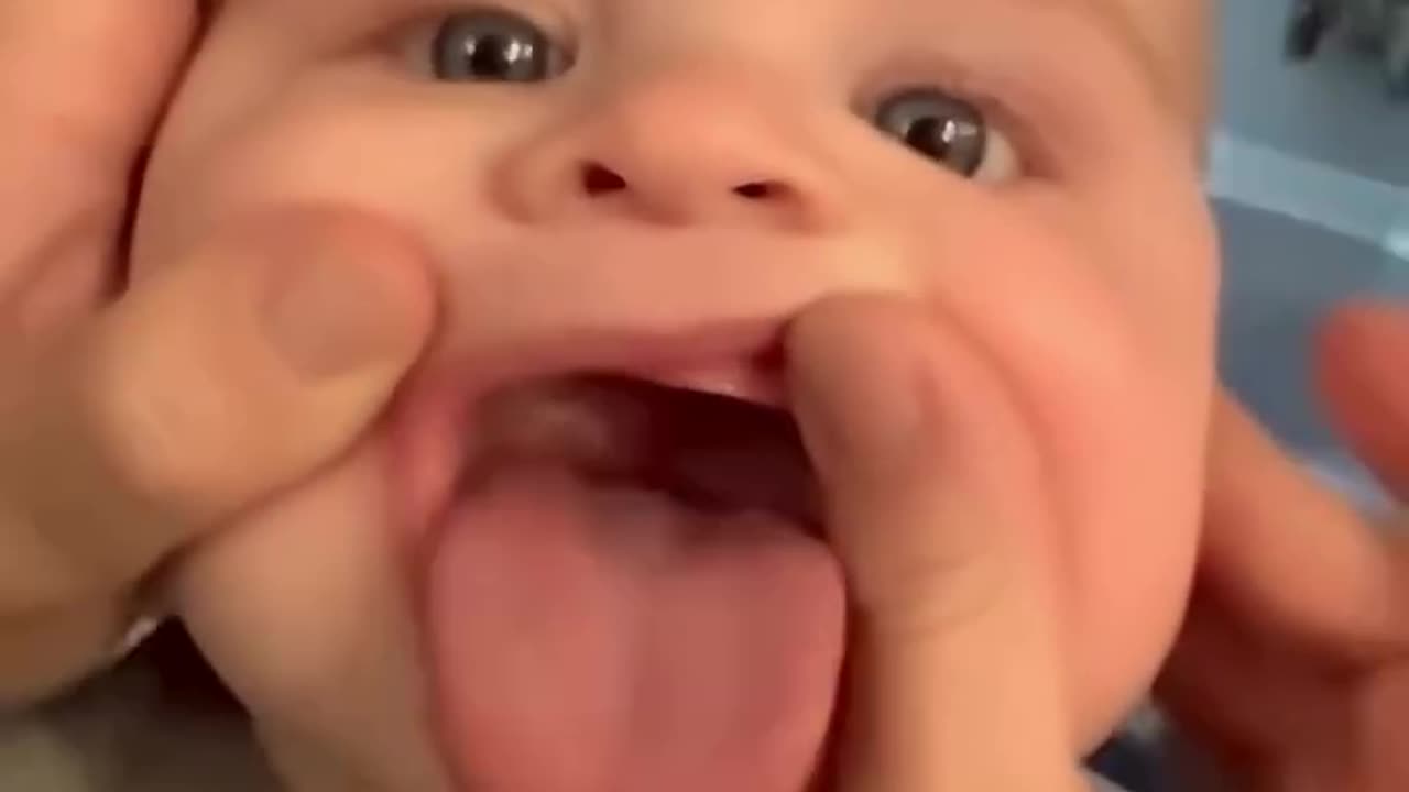 A cute baby attacks his dad's nose