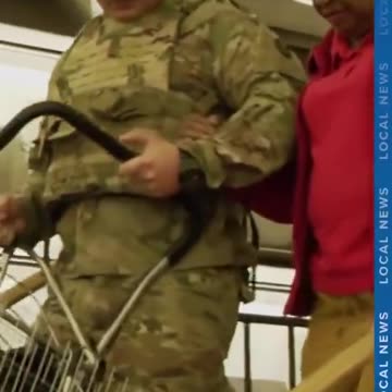 National Guard member helps woman down stairs in Washington, D.C.