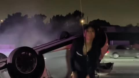 Woman Dances in Front of Her Flipped Tesla