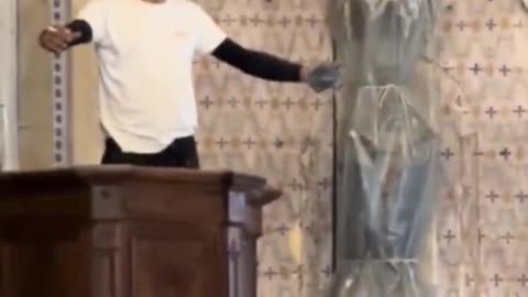 A North African Muslim smokes a cigarette in a church in France and curses in his language.