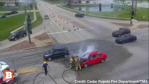 Cedar Rapids, Iowa: A car stopped in the middle of an intersection starts smoking