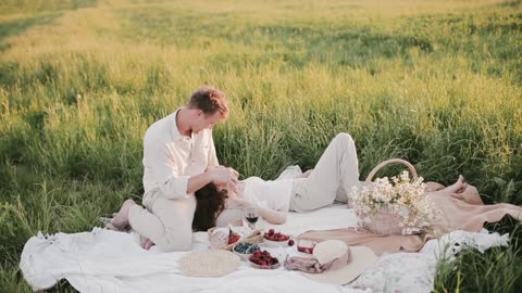 A Passionate Couple Having a Picnic In A Grass Field