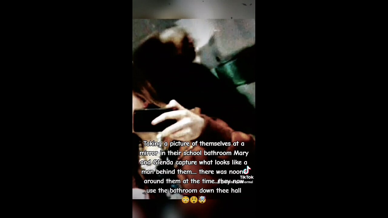 Ghost captured in back of two girls