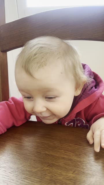 kayla and mommy playing peekaboo with a chair
