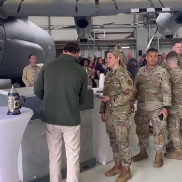 Vice President JD Vance pours some beers for the troops during a refueling stop at Ramstein Air Base