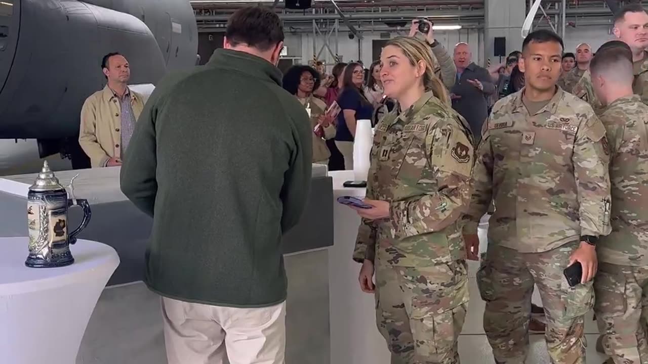 Vice President JD Vance pours some beers for the troops during a refueling stop at Ramstein Air Base