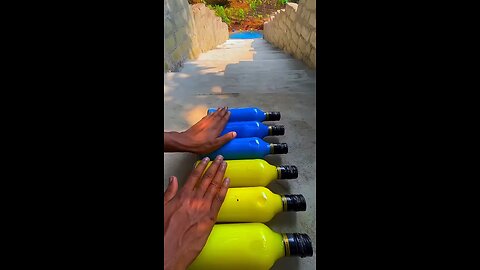 Incredible different colours of bottles falling from stairs to check hardness