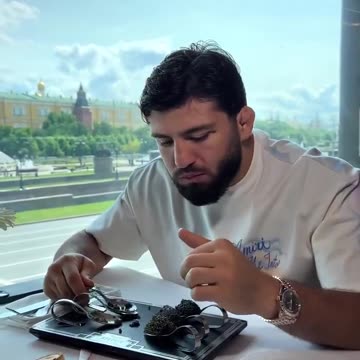 UFC star Arman Tsarukyan eats Black Beluga caviar in Red Square Moscow. Each bite is like 300 bucks.