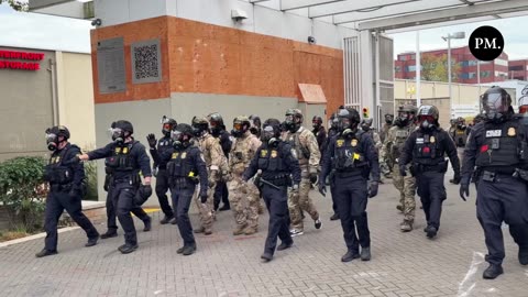 Federal police make an arrest outside the ICE facility in Portland.