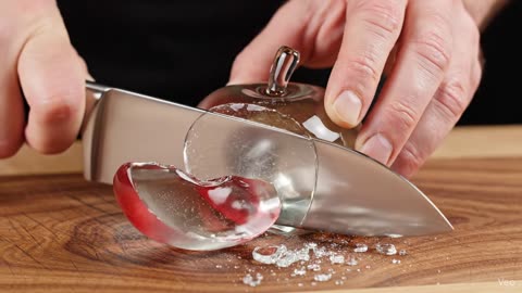 Slicing a crystalline red apple