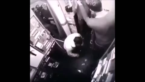 Muslim man prays in the aisle of a passesenger jet