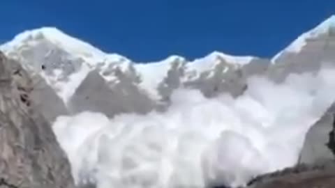 Avalanche surges down the steep face of Annapurna I in Nepal
