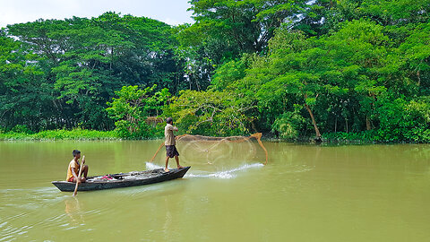 Father and son are fishing in the deep water of the canal on a boat