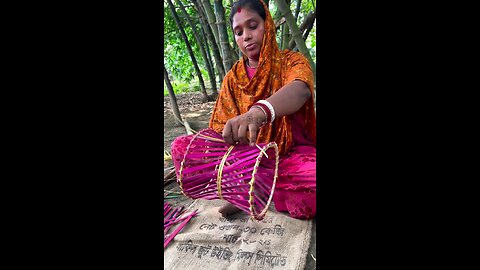 "A sitting stool is being crafted from bamboo.