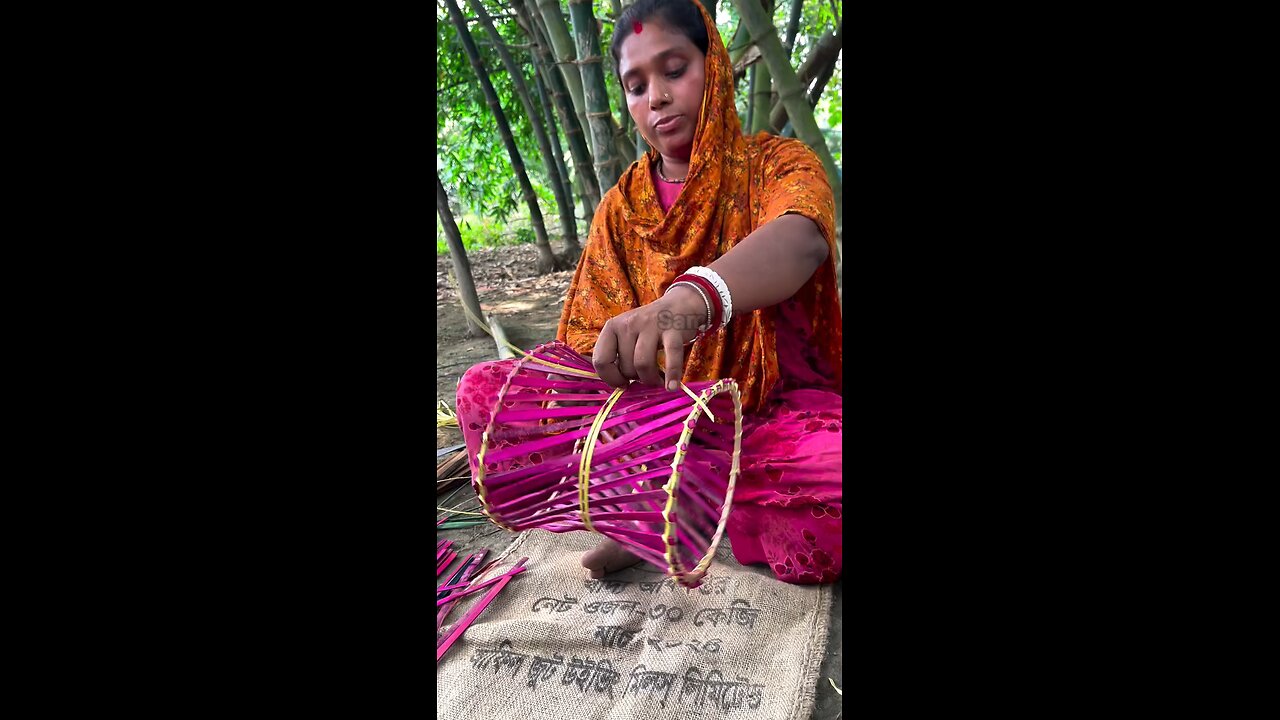 "A sitting stool is being crafted from bamboo.