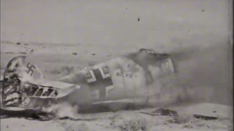 RAAF P-40 Kittyhawks strafing a derelict Messerschmitt Bf 109 circa December 1941