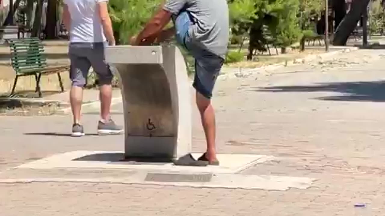 This is Italy. In fountain where children drink, the usual suspect washes his feet