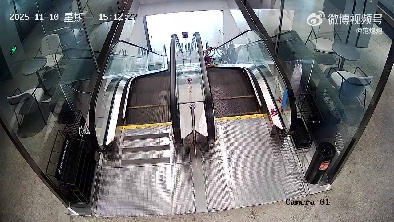Guy takes cycle down the escalator