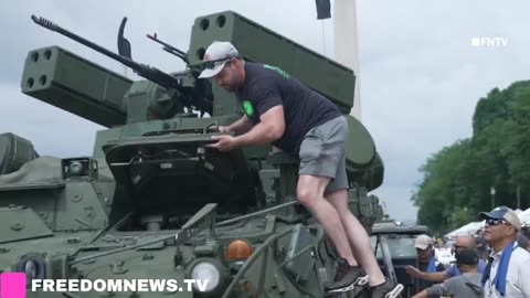 Military parade participants pose with weapons and tanks in Washington DC