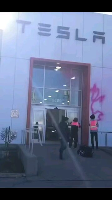 BREAKING: Climate change activists attack Tesla store in Montreal, Canada.