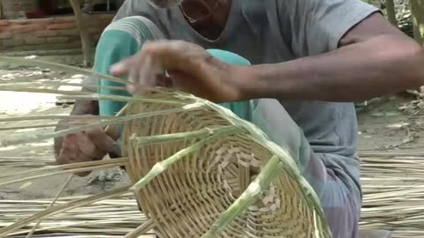Hardworking old uncle Making Bamboo Basket in Village