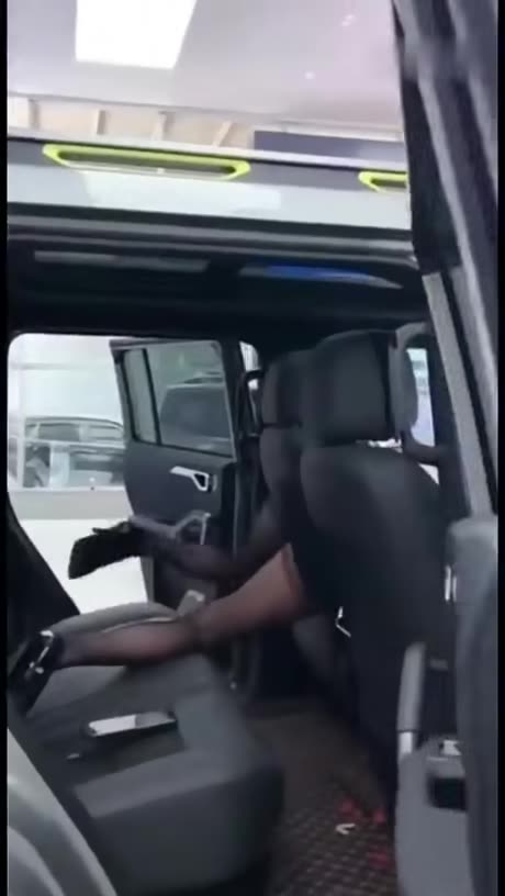 Saleswoman explaining the special feature of the car