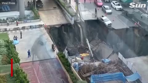 Terrifying moment giant SINKHOLE swallows road outside Bangkok hospital