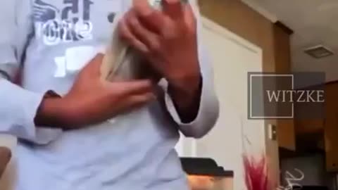 7 year old nigglet pointing a hand gun at camera while flashing cash