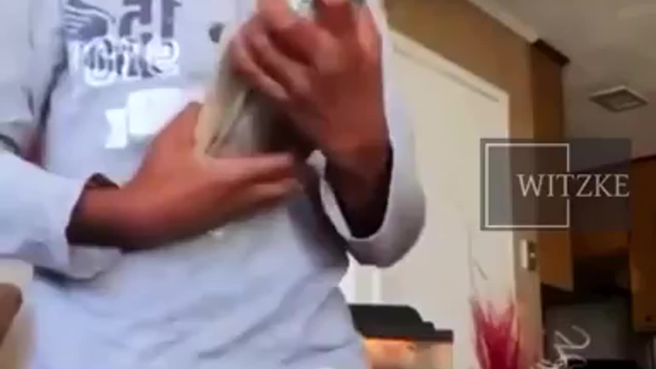 7 year old nigglet pointing a hand gun at camera while flashing cash