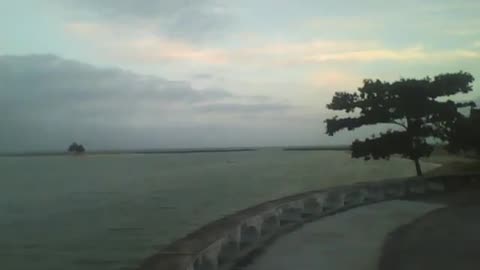 A wonderful view of the sea coast at dusk, beach, buildings, boats and an island! [Nature & Animals]