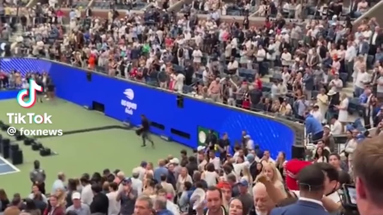 President Donald Trump is signing supporters hats at the U.S. Open