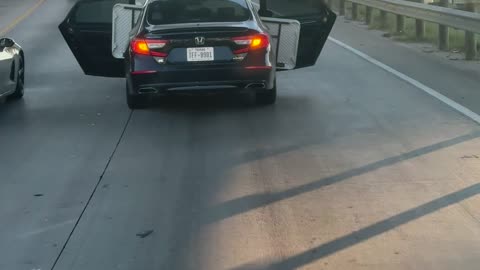 Honda Drives With Doors Open On Highway