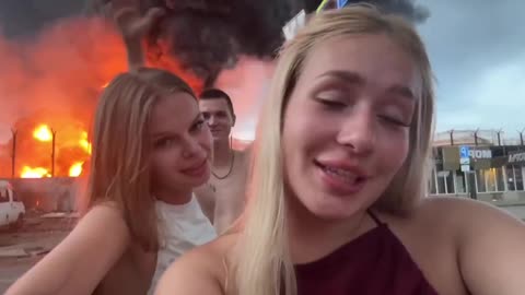 Women arrested after filming in front of burning oil depot hit by Ukrainian drone strike