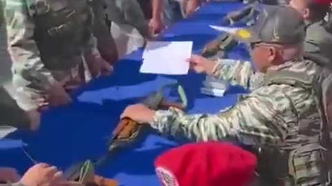 The Venezuelan military has begun distributing rifles to civilians in working-class