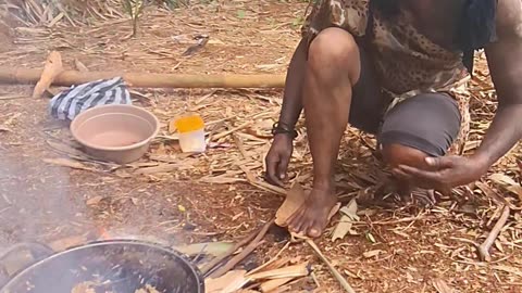 Primitive people are cooking eels