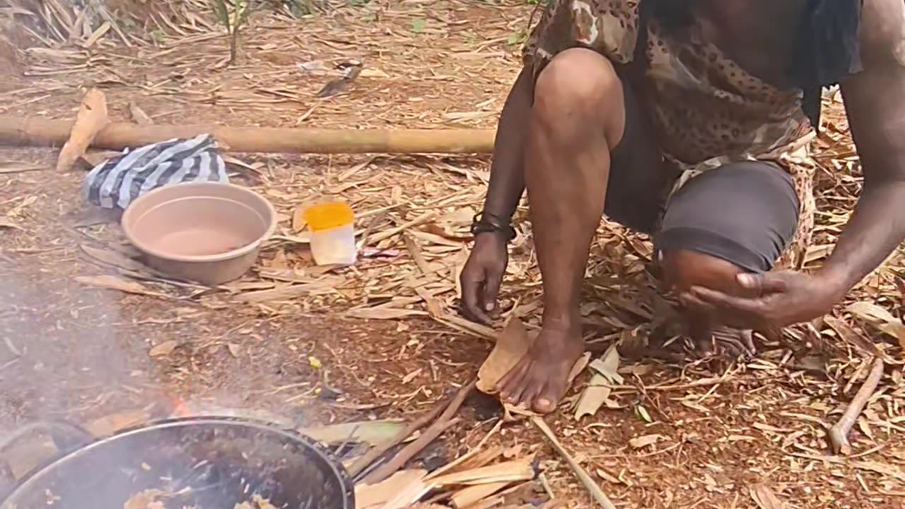 Primitive people are cooking eels